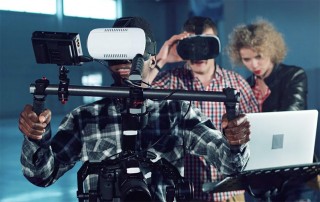 Three people experimenting with shooting VR equipment