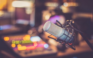 Microphone in a professional recording or radio studio, equipment in a radio stiation blurry background